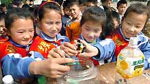 Students collect old used batteries in the Shenzhou School, Xiangfan City of Hubei Province, on April 20, 2009. The Earth Day, celebrated on every April 22, is a day designed to inspire people's awareness and appreciation for the Earth's environment.