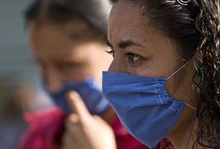 A woman wears a mask to prevent from being infected by the swine flu virus in the Mexico City, capital of Mexico, on April 25, 2009. The World Health Organization (WHO) on Saturday declared the swine flu outbreak in Mexico and the United States a 'public health emergency of international concern' and urged countries to be alert. 