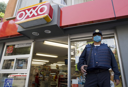 A security man wears a mask to prevent from being infected by the swine flu virus in the Mexico City, capital of Mexico, on April 25, 2009. 