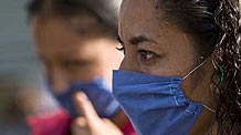 A woman wears a mask to prevent from being infected by the swine flu virus in the Mexico City, capital of Mexico, on April 25, 2009. The World Health Organization (WHO) on Saturday declared the swine flu outbreak in Mexico and the United States a 'public health emergency of international concern' and urged countries to be alert.