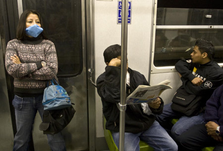 A woman wears a mask as she takes subway in Mexico City, capital of Mexico, on April 24, 2009.