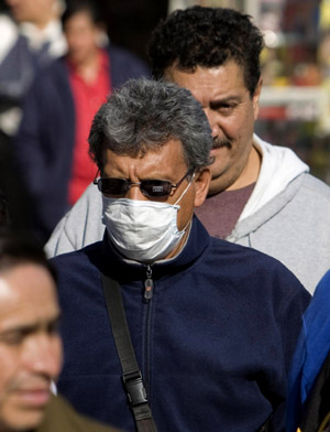 A man wearing a mask walks on a street in Mexico City, capital of Mexico, on April 24, 2009.