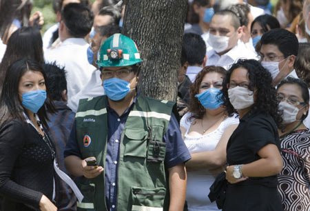 People wearing masks gather outside buildings after an earthquake in Mexico City, captial of Mexico, on April 27, 2009. A 5.6-magnitude earthquake hit southern Mexico on Monday at 11:46 AM local time, with an epicenter 23 kilometers northeast of Zumpango, a small town in the state of Guerrero, and with a deepness of 41.2 kilometers, the US Geological Survey Earthquake Hazards Program reported. The quake was felt in Mexico City. 