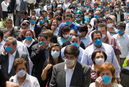 People wearing masks gather outside buildings after an earthquake in Mexico City, captial of Mexico, on April 27, 2009. 