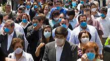 People wearing masks gather outside buildings after an earthquake in Mexico City, captial of Mexico, on April 27, 2009.