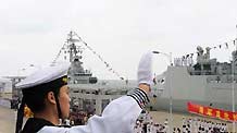 A sailor of Chinese warship DDG-169 Wuhan waves to the people during a welcome ceremony held at a port in Sanya, south China's Hainan Province, on April 28, 2009.