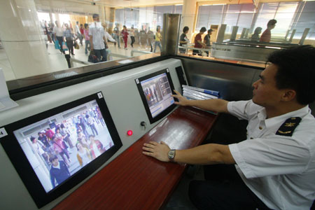 A Chinese quarantine staff checks the body temperature for passengers on arrival at the Gongbei Customs near Zhuhai city in south China's Guangdong Province on April 28, 2009. Chinese government announced Tuesday that no human cases of swine flu have been detected in China and that all precautions against the disease's possible spread have been taken.