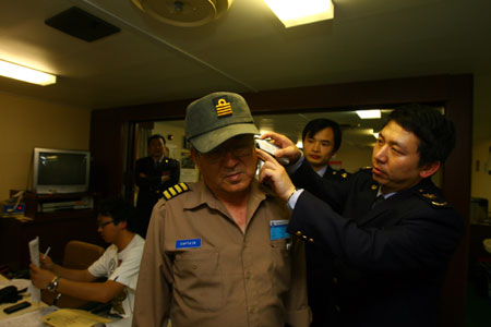 A Chinese quarantine staff checks the body temperature for a foreign sailor on arrival at the Ningbo seaport in east China's Zhejiang Province on April 28, 2009.