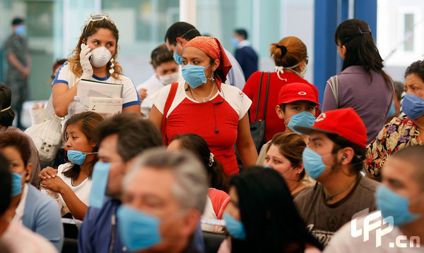 People sit in the waiting room at the Mexico City Navy Hospital to be checked for flu-like symptoms on April 29, 2009 in Mexico City, Mexico. Cases of swine flu, the strain known as H1N1 virus, have been confirmed in nine countries, including Mexico, where at least 2,400 are believed to be infected, with the number of deaths attributed to the virus believed to be more than 150.