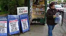 A pedestrian walks past placards of swine flu news at a newsstand in London, the United Kingdom, on April 28, 2009. Leaflets giving advices about the new H1N1 swine flu virus will be sent to every home in Britain, said the British Department of Health on April 29. A newly wed couple in Scotland have been tested positive for the infection of swine flu virus after returning from Mexico, and 22 other people are waiting for test results.