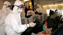 Passengers of AeroMexico flight AM098 receive quarantine checks up on their arrival at the Shanghai Pudong International Airport in east China's Shanghai municipality, on April 30, 2009. It's the first flight from Mexico to China since the spread of swine flu, and serious quarantine measures were taken at the airport.