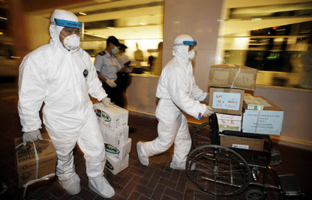 Medical workers transport boxes of disinfectants to the quarantined Metropark Hotel, where the patient of influenza A/H1N1 checked in, in Wanchai of Hong Kong, south China, on May 1, 2009.