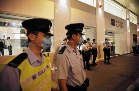 Policemen guard the quarantined Metropark Hotel, where the patient of influenza A/H1N1 checked in, in Wanchai of Hong Kong, south China, on May 1, 2009.