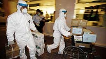 Medical workers transport boxes of disinfectants to the quarantined Metropark Hotel, where the patient of influenza A/H1N1 checked in, in Wanchai of Hong Kong, south China, on May 1, 2009.