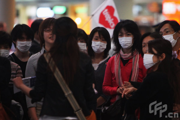 Passengers wear face masks as they arrive at Beijing Capital International Airport on May 2, 2009 in Beijing, China. The first cases of A/H1N1 flu were reported in Asia on Saturday, prompting health officials to quarantine the sick and take other actions to prevent a spread of the outbreak that has rattled the world for a week. 