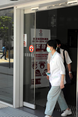 A medical worker walks out the Princess Margaret Hospital, which admitted the Mexican man with Influenza A/H1N1, on May 2, 2009. 