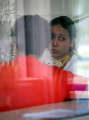 Two people wait for being examined in Beijing Ditan Hospital in Beijing, capital of China, May 2, 2009. Beijing Ditan Hospital has been designated to treat influenza A/H1N1 by Beijing Health Bureau since April 28. (Xinhua/Luo Xiaoguang)