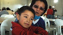 Four-year-old Edgar Hernandez (L) who has recovered from the A/H1N1 flu influenza recently, and his mother rest in a free dining room at his hometown in Veracruz state in Mexico on May 2, 2009. Hernandez is the first patient who was infected by the A/H1N1 flu influenza in Mexico.