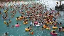 Chinese tourists enjoy leisure time of their holiday at a resort named 'China Dead Sea' in Suining City, southwest China's Sichuan Province, on May 2, 2009. Some 10,000 tourists rushed to the resort Saturday for May Day holiday.