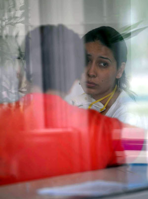 Two people wait for being examined in Beijing Ditan Hospital in Beijing, capital of China, on May 2, 2009. Beijing Ditan Hospital has been designated to treat influenza A/H1N1 by Beijing Health Bureau since April 28.