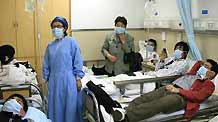 Some patients are seen at the fever diagnosis ward of Shanghai East Hospital in Shanghai, east China, on May 3, 2009. Shanghai East Hospital opened fever diagnosis ward and express way for the fever patients for preventing influenza A/H1N1.