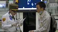 A Chinese citizen waits for boarding at Benito Juarez international airport in Mexico City, capital of Mexico, on May 5, 2009. A total of 79 Chinese citizens left Mexico City early on Tuesday aboard a chartered flight sent by the Chinese government. The plane took off from Mexico City, heading towards Tijuana, northern Mexico, to lift 20 more Chinese before returning to China.