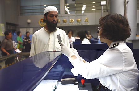 Passengers of T98 train go through customs at Beijing West Railway Station in Beijing, capital of China, on May 5, 2009. T98 train connecting Kowloon and Beijing arrived on Tuesday. This was the first arrival of a train from Hong Kong in Beijing since the first human influenza A/H1N1 case was confirmed in Hong Kong, south China, on May 1.