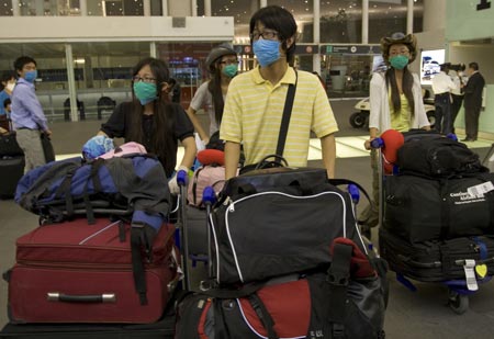 Chinese citizens wait for boarding at Benito Juarez international airport in Mexico City, capital of Mexico, on May 5, 2009. A total of 79 Chinese citizens left Mexico City early Tuesday aboard a chartered flight sent by the Chinese government. The plane took off from Mexico City, heading towards Tijuana, northern Mexico, to lift 20 more Chinese before returning to China. 