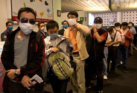 Chinese citizens wait for boarding at Benito Juarez international airport in Mexico City, capital of Mexico, on May 5, 2009. A total of 79 Chinese citizens left Mexico City early Tuesday aboard a chartered flight sent by the Chinese government. The plane took off from Mexico City, heading towards Tijuana, northern Mexico, to lift 20 more Chinese before returning to China. 