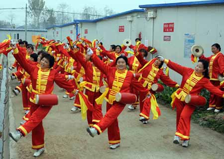 Members of a waist drum team attend a rehearsal for a performance during the upcoming Spring Festival in Wudu Town of Jiangyou City, southwest China's Sichuan Province, on January 20, 2009. Wudu Town is one of the areas hit seriously in the May 12 quake last year, with 2,071 people dead and 16,598 houses destroyed. The Chinese traditional Spring Festival, or lunar New Year, starts from January 26 this year.