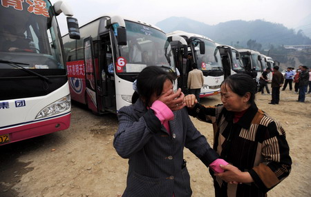 Earthquake survivors weep to separate with old folks as they prepare to leave for new houses as part of a relocation project in Qingchuan County, southwest China's Sichuan Province, on May 6, 2009. 