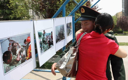 Earthquak survivor Song Yanmei hugs a military soldier in Luoyang, capital city of central China's Henan Province,on May 6, 2009.