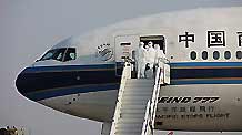 Inspectors walk aboard the chartered plane from Mexico to check the health of Chinese citizens from Mexico after the plane arrived in Shanghai on May 6, 2009. The chartered plane sent to fetch Chinese citizens from Mexico arrived in Shanghai on Wednesday afternoon, with 98 passengers and 21 crew members on board.