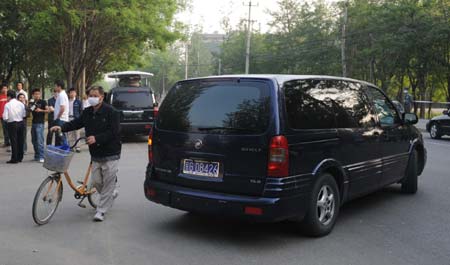 A car carrying the quarantined passengers from the Mexico City-Shanghai flight AM098, where a Mexican man was confirmed to be infected with influenza A/H1N1, runs out of the gate of the Guomenlu Hotel in Beijing, China, May 7, 2009. The passengers quarantined in the Chinese mainland who took the same flight with the Mexican were out of quarantine on Thursday.