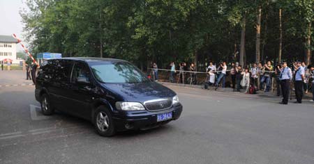 A car carrying the quarantined passengers from the Mexico City-Shanghai flight AM098, where a Mexican man was confirmed to be infected with influenza A/H1N1, runs out of the gate of the Guomenlu Hotel in Beijing, China, May 7, 2009. The passengers quarantined in the Chinese mainland who took the same flight with the Mexican were out of quarantine on Thursday.