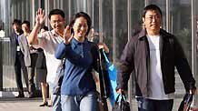 Several Chinese passengers from the Mexico City-Shanghai flight AM098, where a Mexican man was confirmed to be infected with influenza A/H1N1, walk out of the hotel as the quarantine ends in Shanghai, east China, on May 7, 2009.