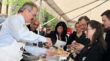 Canadian Agriculture Minister Gerry Ritz (1st L) gives out pork burgers to government officials at a pork BBQ luncheon on Parliament Hill in Ottawa, capital of Canada, on May 6, 2009. Ritz stressed here on Wednesday that Canadian pork is safe while urging domestic consumers to eat more pork to help the struggling pork industry, hard-hit by bans from foreign countries following the outbreak of influenza A/H1N1.