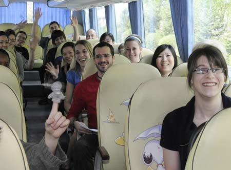 Canadian students who took a flight to Changchun on May 2 from Canada via Beijing for exchange studies, smile and wave their hands on a coach as the quarantine ends in Changchun, capital of northeast China's Jilin Province, on May 7, 2009.