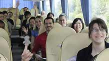 Canadian students who took a flight to Changchun on May 2 from Canada via Beijing for exchange studies, smile and wave their hands on a coach as the quarantine ends in Changchun, capital of northeast China's Jilin Province, on May 7, 2009.