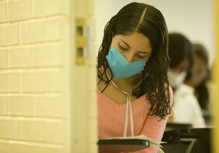 A student wearing a mask attends a class at the National Autonomous University of Mexico (NAUM) in the Mexico City on May 7, 2009.