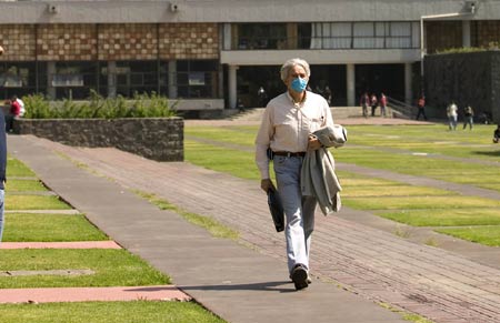 A teacher wearing a mask walks in the National Autonomous University of Mexico (NAUM) in the Mexico City on May 7, 2009. 