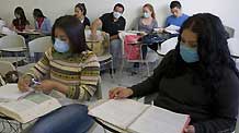 Students wearing masks attend a class at the National Autonomous University of Mexico (NAUM) in the Mexico City on May 7, 2009.