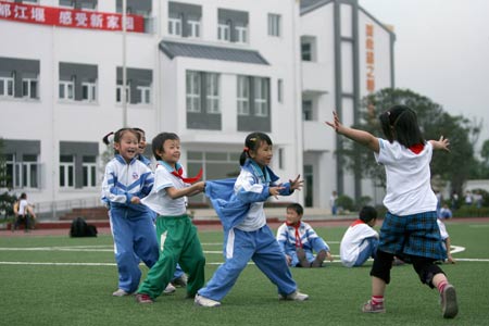 Pupils play games at a primary school in Chongyi Town of Dujiangyan City, southwest China's Sichuan Province, May 9, 2009. The school, reconstructed after the deadly May 12 earthquake last year with the aid of Shanghai Municipality in east China, can resist magnitude-8.0 quake. (Xinhua/Zheng Yue)
