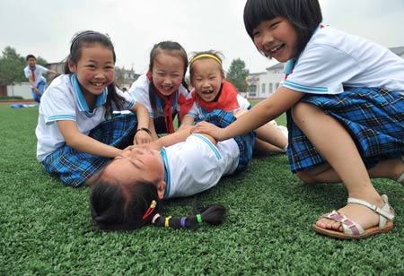 Pupils play games at a primary school in Chongyi Town of Dujiangyan City, southwest China's Sichuan Province, May 9, 2009. The school, reconstructed after the deadly May 12 earthquake last year with the aid of Shanghai Municipality in east China, can resist magnitude-8.0 quake. (Xinhua/Yang Lei) 