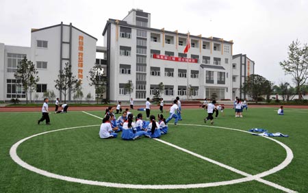 Pupils attend a sports class at a primary school in Chongyi Town of Dujiangyan City, southwest China's Sichuan Province, May 9, 2009. The school, reconstructed after the deadly May 12 earthquake last year with the aid of Shanghai Municipality in east China, can resist magnitude-8.0 quake. (Xinhua/Yang Lei) 