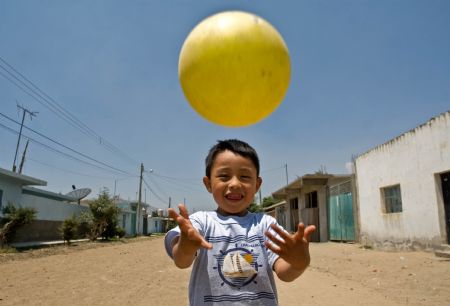 The first A/H1N1 flu patient Edgar Hernandez plays a ball in La Gloria village, Mexico's eastern coast state of Veracruz, on May 8, 2009. Edgar has recovered and led a normal life here.