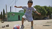 The first A/H1N1 flu patient Edgar Hernandez plays a ball in La Gloria village, Mexico's eastern coast state of Veracruz, on May 8, 2009. Edgar has recovered and led a normal life here.