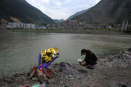 A mother mourns for her child who was killed in last year's May 12 earthquake in Beichuan, a hardest-hit area in the disaster, in southwest China's Sichuan Province, on May 10, 2009. Parents who lost their children came back to Beichuan as the first anniversary of the disaster approaches.