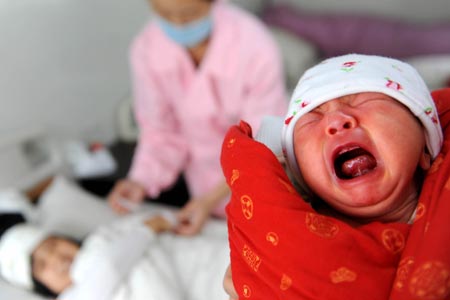 Zhang Xiaoyan's newborn cries at a prefab hospital in Qingchuan, southwest China's Sichuan Province, on May 10, 2009.