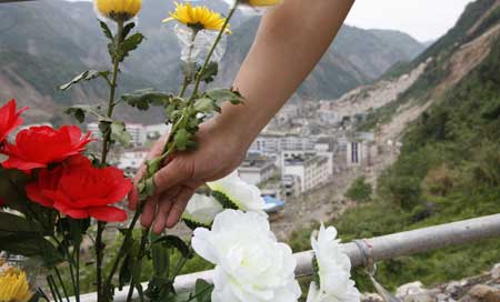 Flowers are presented in commemoration of the victims of the May 12 earthquake last year, outside Beichuan City, which was seriously damaged in the earthquake, southwest China's Sichuan Province, on May 10, 2009. As the first anniversary of the earthquake approaches, people all over China commemorate the disaster in different ways. 
